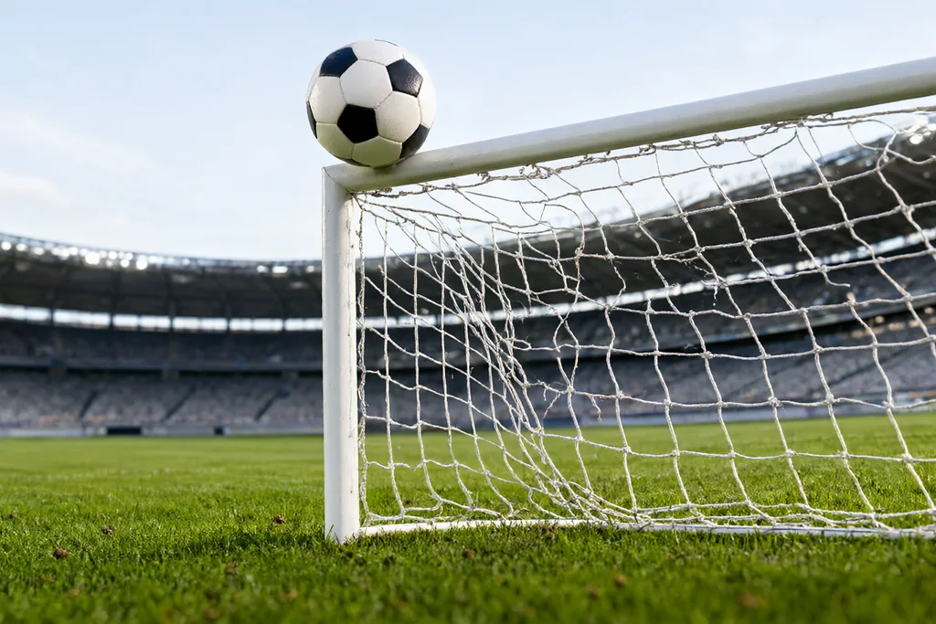 Player arms held behind the back inside a defensive wall at a free kick